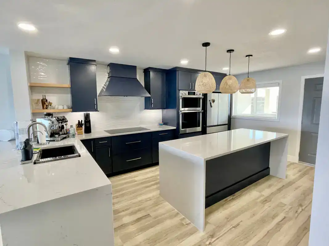 Modern kitchen in Suffolk County, NY featuring black cabinets, white countertops, and restored cabinetry.